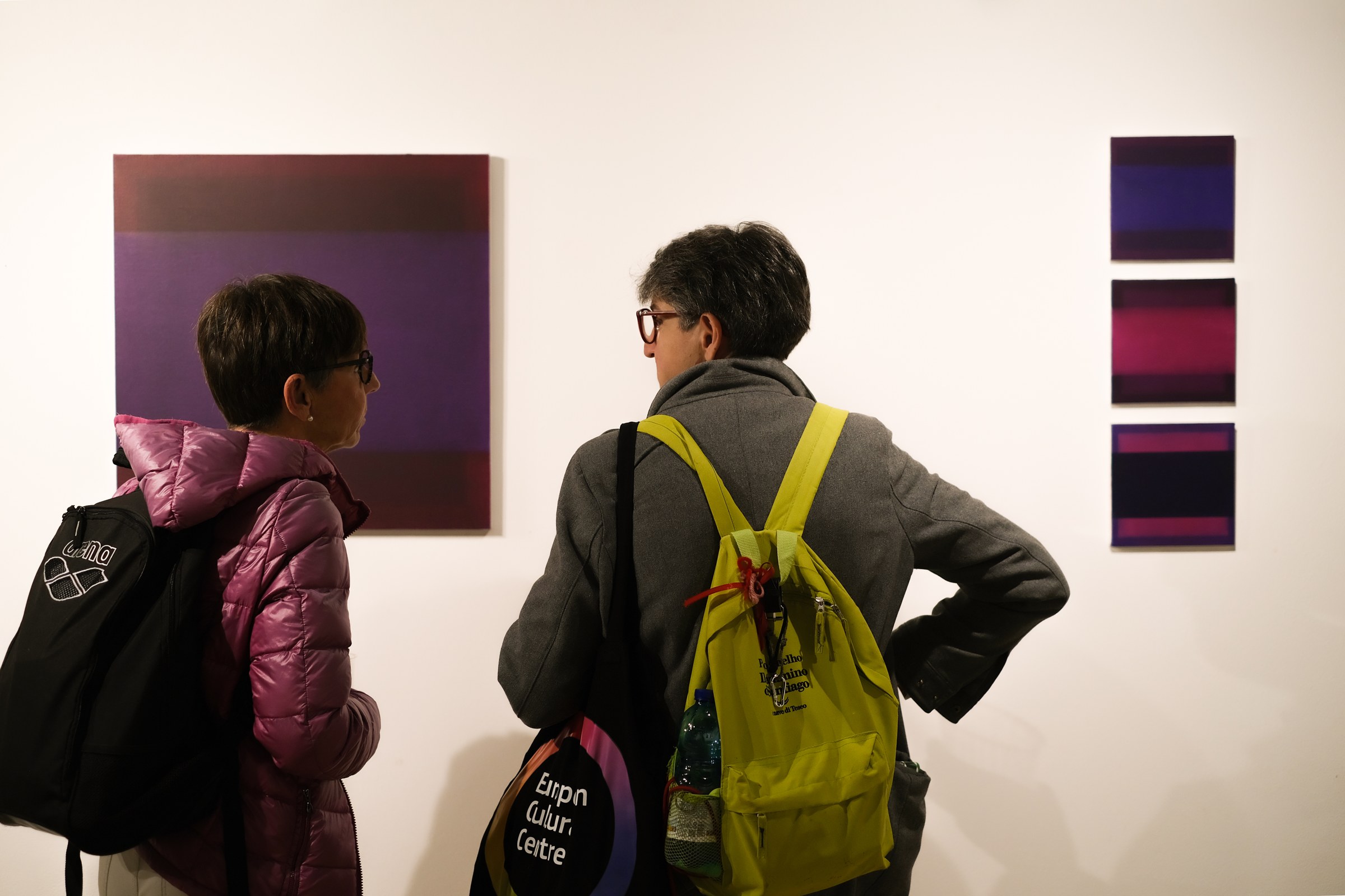 Visitors viewing paintings at Liminal Space